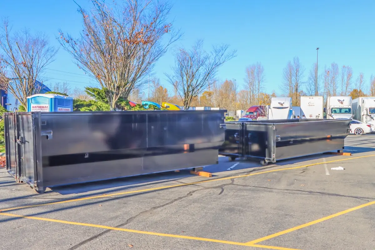 Professional dumpster rental service with roll-off container on residential driveway in New Providence